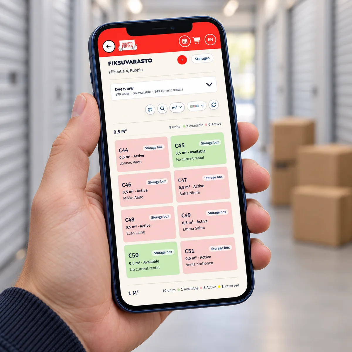 A hand-held phone showing Easy Storage manager cards in an illustrative storage corridor.
